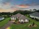 Luxury home with landscaped yard and driveway, aerial view at 5096 Greens Dr, Lady Lake, FL 32159