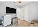 Bright home office with desk, seating, and large TV at 5096 Greens Dr, Lady Lake, FL 32159
