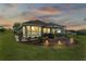Stunning home exterior with a covered patio and landscape lighting at 5096 Greens Dr, Lady Lake, FL 32159