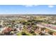 Aerial view of a community with townhomes, a clubhouse, and a golf course in the distance at 5279 Bowline Ct, Oxford, FL 34484