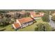 Aerial view showcasing a two-story townhome featuring a screened patio and lush lawn at 5279 Bowline Ct, Oxford, FL 34484