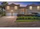 Townhouse exterior with two-car garage and landscaped entryway at 5279 Bowline Ct, Oxford, FL 34484