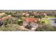 Aerial view showing the property's location within a well-maintained community by a lake at 5279 Bowline Ct, Oxford, FL 34484