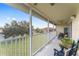 Extended screened balcony with rocking chairs offering a community view at 5279 Bowline Ct, Oxford, FL 34484