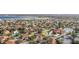An aerial view showcasing a community of townhomes near a lake and pool at 5279 Bowline Ct, Oxford, FL 34484