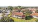 Aerial view of the back of a two-story townhome with a screened-in patio and surrounding lawn at 5279 Bowline Ct, Oxford, FL 34484