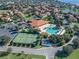 Aerial view of community amenities including pool, tennis courts, and clubhouse at 5279 Bowline Ct, Oxford, FL 34484