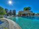 Relaxing community pool with a rock waterfall feature at 5279 Bowline Ct, Oxford, FL 34484