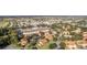 Aerial view of a community with townhomes, a clubhouse, and a golf course in the distance at 5279 Bowline Ct, Oxford, FL 34484