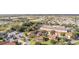 An aerial view of the community, showcasing a large clubhouse and nearby townhouses at 5279 Bowline Ct, Oxford, FL 34484