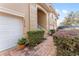 Townhome entry with brick pavers, shrubs, and a stairway leading to the front door at 5279 Bowline Ct, Oxford, FL 34484