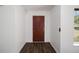Interior entryway with dark hardwood floors and red door at 2101 Sw 3Rd St, Ocala, FL 34471