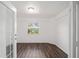 Bright bedroom with wood-look floors and a window offering an outdoor view at 2101 Sw 3Rd St, Ocala, FL 34471