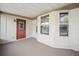 Covered patio with a door and windows, offering extra space at 2101 Sw 3Rd St, Ocala, FL 34471