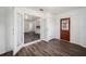 View of an open floor plan with wood-look floors and French doors at 2101 Sw 3Rd St, Ocala, FL 34471
