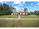 Single-story house with a red door and a green lawn at 2101 Sw 3Rd St, Ocala, FL 34471