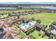 Luxury community pool and clubhouse with palm trees at 119 Crescent Moon Dr, Groveland, FL 34736