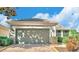 One story house with a two car garage and a landscaped yard at 119 Crescent Moon Dr, Groveland, FL 34736