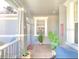 Inviting front porch with tile flooring and potted plants at 119 Crescent Moon Dr, Groveland, FL 34736