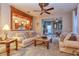 Bright and airy living room featuring two sofas, a coffee table, and a view into the kitchen at 13412 Fox Glove St, Winter Garden, FL 34787
