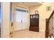 Spacious entryway with double doors, tile flooring, and a wooden storage bench at 13412 Fox Glove St, Winter Garden, FL 34787