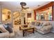 Spacious living room with comfortable seating, a large coffee table, and views of the kitchen and staircase at 13412 Fox Glove St, Winter Garden, FL 34787