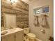 Clean bathroom with wood-look tile and updated vanity at 13412 Fox Glove St, Winter Garden, FL 34787