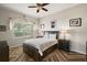 Bright bedroom with a comfortable bed, nightstands, and a large window at 24124 Robinwood St, Leesburg, FL 34748