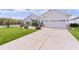 One-story house with a two-car garage and landscaped yard at 9702 Pepper Tree Pl, Wildwood, FL 34785