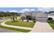 Ranch-style house with a two-car garage and landscaped yard at 9702 Pepper Tree Pl, Wildwood, FL 34785