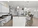 Modern kitchen with white cabinets, granite countertops, and breakfast bar at 9702 Pepper Tree Pl, Wildwood, FL 34785