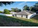 Single story house with solar panels and grassy backyard at 1836 Ridge Valley St, Clermont, FL 34711