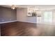 Bright living room with dark laminate flooring and open concept kitchen at 1836 Ridge Valley St, Clermont, FL 34711