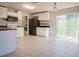 Kitchen with white cabinets, stainless steel appliances, and tile floor at 1836 Ridge Valley St, Clermont, FL 34711