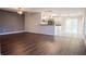 Bright living room with dark laminate flooring and open concept kitchen at 1836 Ridge Valley St, Clermont, FL 34711