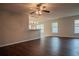 Bright living room with laminate wood floor, ceiling fan and view into kitchen at 1836 Ridge Valley St, Clermont, FL 34711