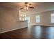 Bright living room with laminate wood floor, ceiling fan and view into kitchen at 1836 Ridge Valley St, Clermont, FL 34711