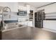 Modern kitchen featuring stainless steel appliances and dark countertops at 1836 Ridge Valley St, Clermont, FL 34711