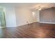Living room with dark laminate flooring and access to entry way at 1836 Ridge Valley St, Clermont, FL 34711