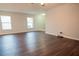 Spacious living room with dark laminate flooring and lots of natural light at 1836 Ridge Valley St, Clermont, FL 34711