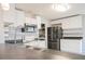 Kitchen with white cabinets, stainless steel appliances, and island at 1836 Ridge Valley St, Clermont, FL 34711