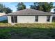 Single story house with solar panels and grassy backyard at 1836 Ridge Valley St, Clermont, FL 34711