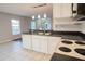 Kitchen with white cabinets, stainless steel appliances, and tile floor at 1836 Ridge Valley St, Clermont, FL 34711