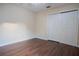 Bright bedroom featuring wood-look floors and a double door closet at 1836 Ridge Valley St, Clermont, FL 34711