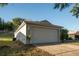 Attached garage with large door and exterior lighting at 1836 Ridge Valley St, Clermont, FL 34711