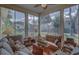Relaxing sunroom with ample seating and views of the backyard at 5000 Portsmouth St, Tavares, FL 32778