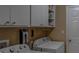 Convenient laundry room with washer, dryer, and overhead cabinets at 5000 Portsmouth St, Tavares, FL 32778