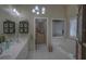 Elegant bathroom with double vanity and soaking tub at 5000 Portsmouth St, Tavares, FL 32778