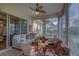 Bright sunroom with comfy seating and large windows at 5000 Portsmouth St, Tavares, FL 32778