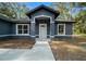 Front view of a new home with gray siding at 14 Guava Terrace Trce, Ocklawaha, FL 32179